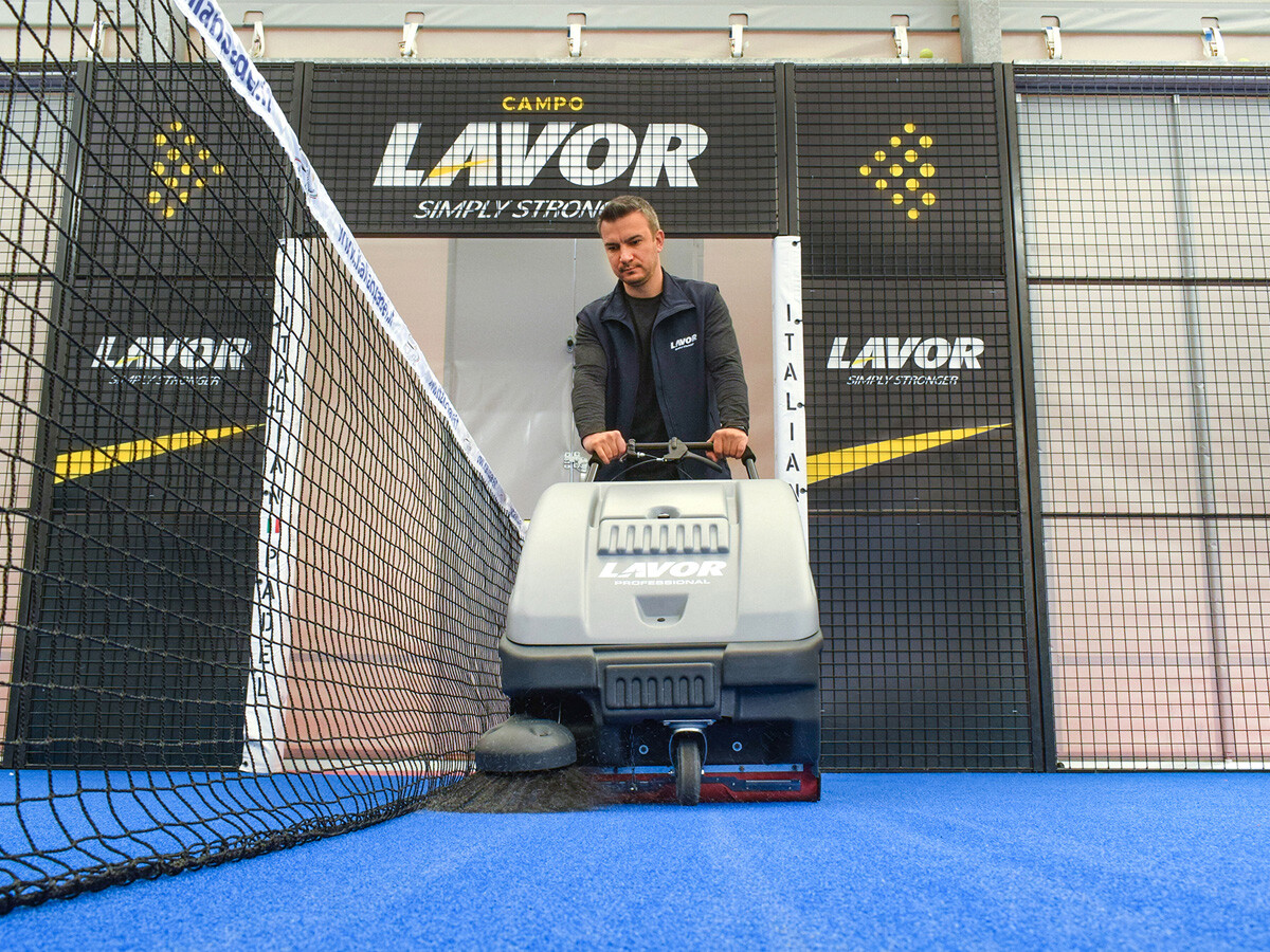 cleaning the padel courts with a sweeper